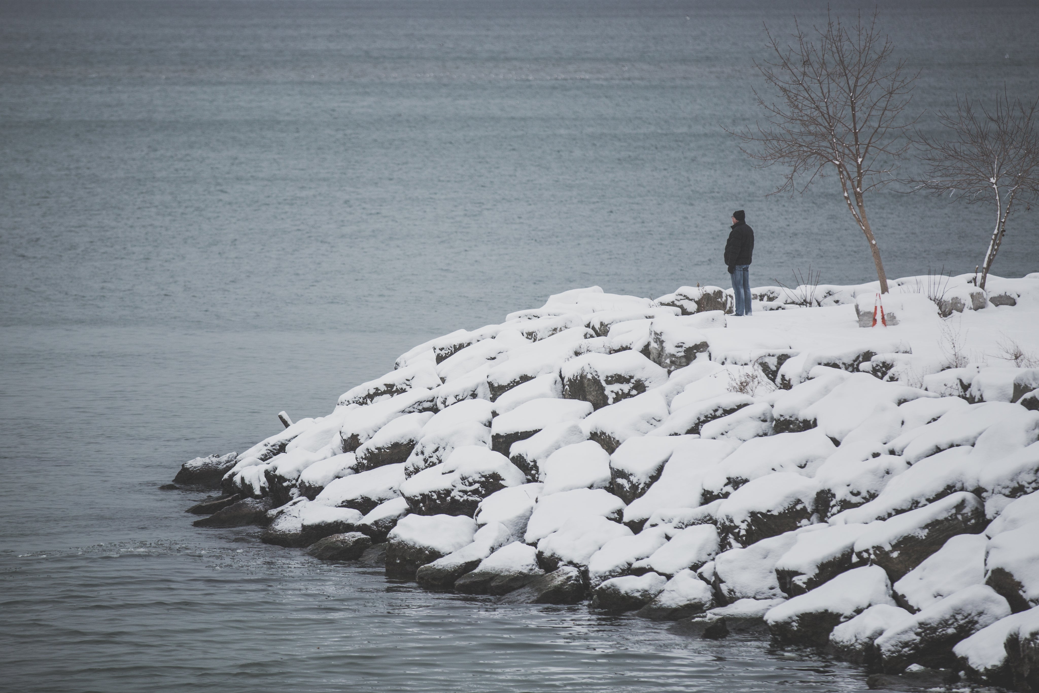 man-at-snowy-waters-edge.jpg